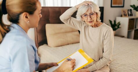 Senior woman looking at different care options with adult woman.