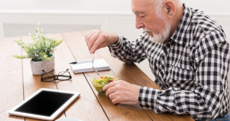 Older adult man at dinner table with loss of appetite