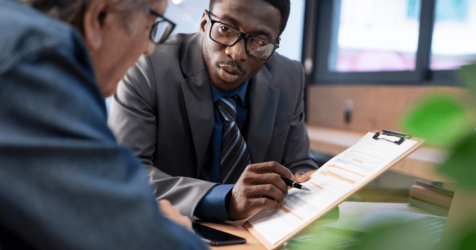 Senior man meeting with financial advisor on how to fund senior living expenses.