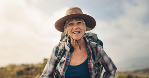 Elder woman outdoors for a hike a solo ager.