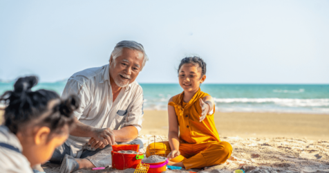 Senior man on beach traveling with grandkids